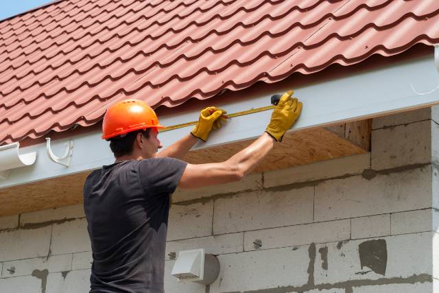 Gutter installation by worker